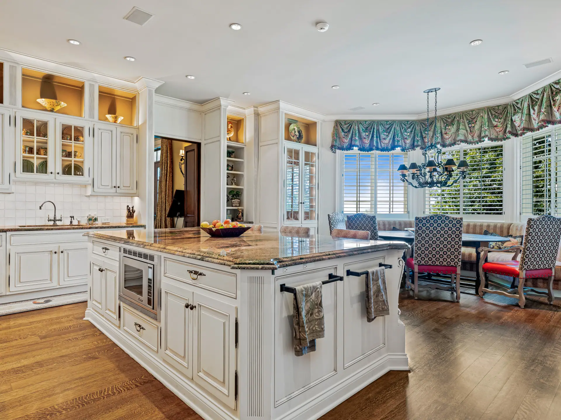 Chef's kitchen with granite island and custom cabinetry