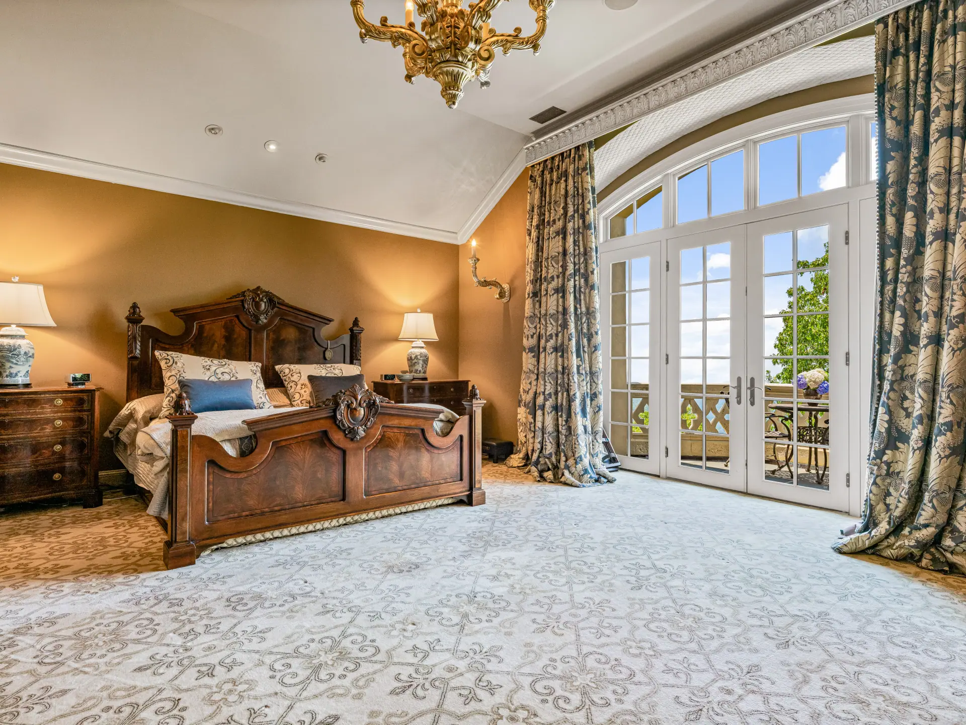 Primary bedroom with French doors to a balcony