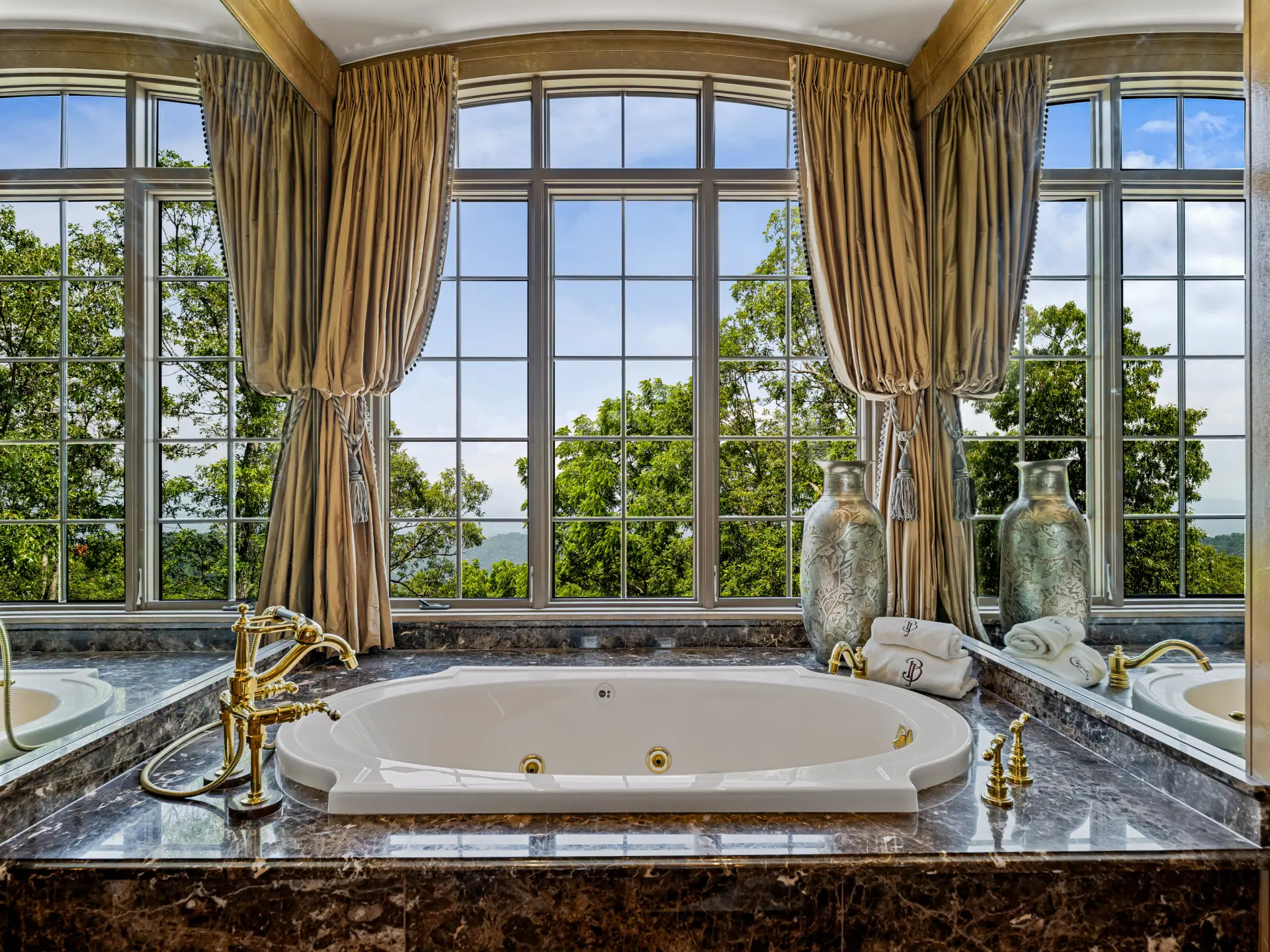 Two-person Jacuzzi tub framed by mountain-view windows