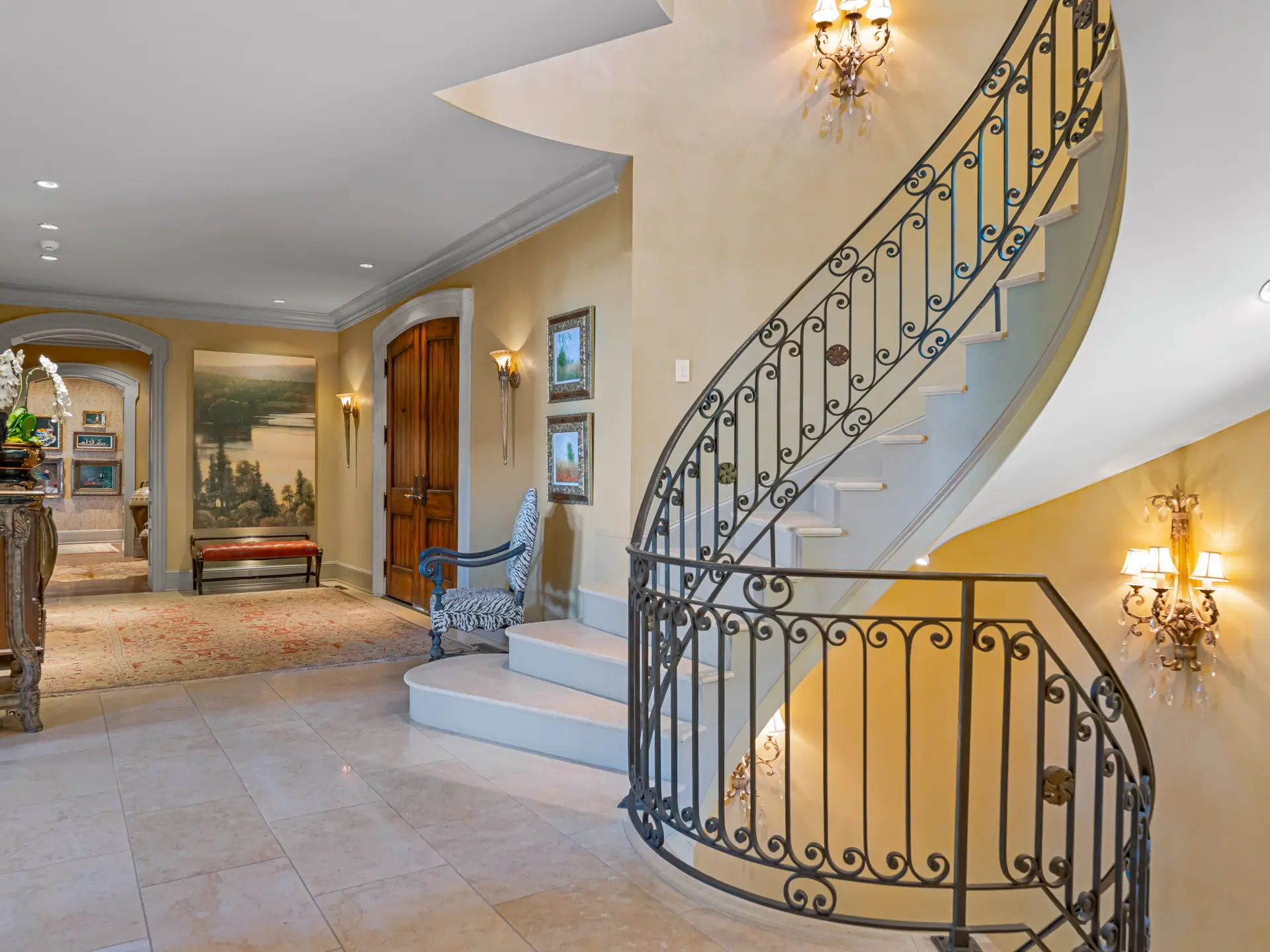 Sweeping stair with custom iron balustrade